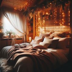 a bed in a room with lights on the wall and curtains hanging from the ceiling