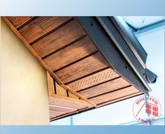 the underside of a wooden ceiling with metal brackets