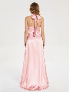 the back of a woman wearing a pink dress with a bow on it's neck