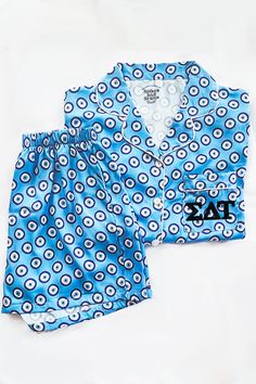 Our Greek Letter Evil Eye Pajamas are made from an ultra soft satin blend fabric, feature a breathable and airy fit, and are comfortable beyond your nightly dreams. With each piece uniquely designed by us, our small team puts an abundance of time, love, dedication, and detail into our eclectic loungewear collection. We are proud to female and family owned & officially Greek licensed. Features a button front shirt, single chest pocket, and elastic waist shorts with pockets. Your sorority letters Preppy Pjs, Sleep Ware, 2024 Clothes, Kappa Delta Chi, Phi Sigma Rho, Alpha Epsilon Phi, Eye Products, Sigma Delta Tau, Sorority Letters