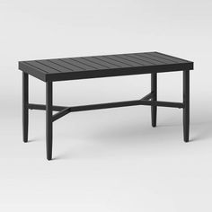 the table is made from black wood and has an iron frame, with two legs that are