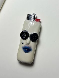 a bottle shaped like a face with sunglasses on it's head and eyes painted on the side