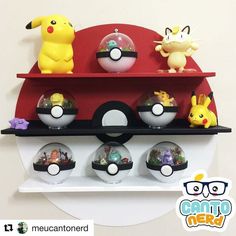 the pokemon figurines are sitting on the shelf above the poke ball display case