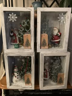 three glass shelves with christmas decorations in them