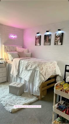 a bed room with a neatly made bed and some pictures on the wall above it