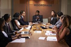 a group of people sitting around a conference table