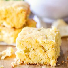 two pieces of cake sitting on top of a wooden cutting board