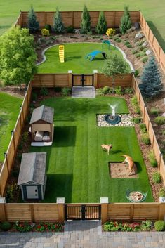 an aerial view of a backyard with grass and wooden fenced in areas for animals