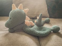 two crocheted stuffed animals sitting on a couch