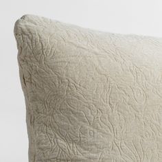 a white pillow with an intricate design on it