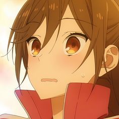 an anime character with brown eyes and long hair, wearing a red shirt looking at the camera