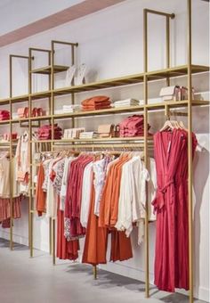 a clothing store with clothes hanging on racks