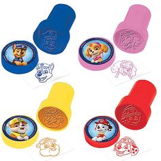 the paw patrol stampers are in various colors and shapes, including blue, yellow, red, pink, orange