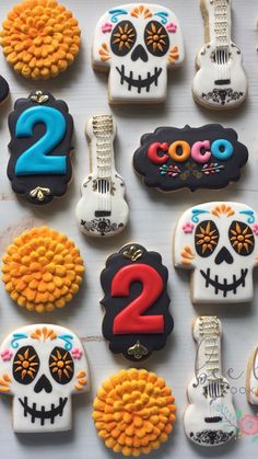 decorated sugar cookies with the number two on them are arranged to look like guitars and skulls