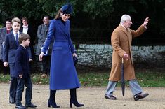 the queen and prince are walking with their children