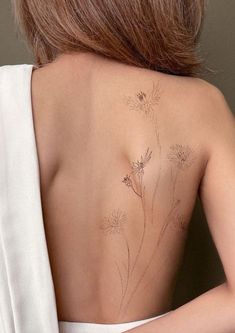 the back of a woman's body with flowers on it