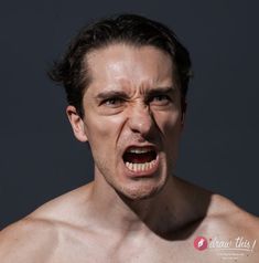 a shirtless man with his mouth open and an angry look on his face,