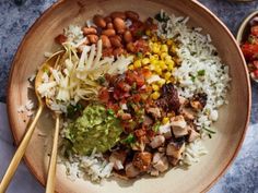 a bowl filled with rice, beans and vegetables