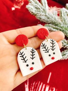 two snowmen wearing red and white earrings