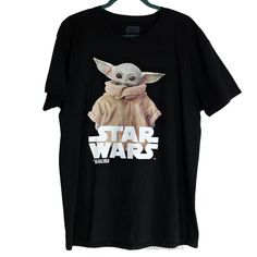 This Is A Brand New With Tags Star Wars Disney Men's Grogu "Baby Yoda" Black Cotton T-Shirt. This Top Features Soft Black Knit Cotton Fabric, Short Sleeves, Crew Neckline, And A Large Star Wars Logo Graphic With The Iconic "The Mandalorian" Character Grogu. High-Quality Disney X Primark Exclusive! Us Men's Size Large 100% Cotton All Orders Are Packaged With And Are Shipped Out Asap! Questions? Leave Us A Comment! We Are More Than Happy To Help! New To Poshmark? Use The Invite Code Dailyshopper73 Star Wars Disney, Star Wars Logo, Star Wars The Mandalorian, Star Wars Shirts, Disney Men, The Mandalorian, Disney Star Wars, Disney Shirts, Us Man