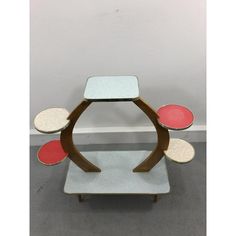 a table with three different colored plates on it and one is made out of wood