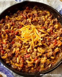 a skillet filled with pasta and ground beef