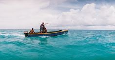 two men in a small boat on the ocean