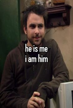 a man sitting in front of a computer with the words he is me i am him