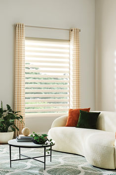 Organic modern living room with curved boucle sofa, abstract circles green and white rug and wireframe coffee table with marble top. Cream dual zebra roller shades dress the window layered with sheer stripe grommet drapery. Window Treatments, Bali, The Way, Curtains, Shades, Pattern, Color, Home Decor