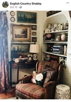 an old fashioned chair in front of a book shelf with pictures on the wall behind it