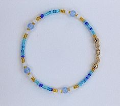 This beaded bracelet is made with 14k gold-filled metal clasps  Anti-tarnish Water safe Size: 7 inches long Blue Beaded Bracelets With Gold Beads, Adjustable Blue Bracelets With Gold Beads, Blue Stretch Bracelet With Gold Round Beads, Blue Stretch Bracelet With Gold Beads, Blue Gold Beaded Bracelet, Blue Gold Beads Bracelet, Blue Beaded Bracelets With Lobster Clasp For Gift, Blue Beaded Bracelets With Lobster Clasp, Blue Beaded Bracelets