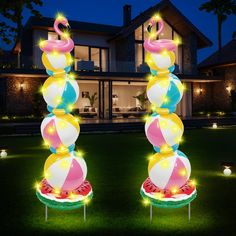 an inflatable flamingo and watermelon float with lights on the lawn