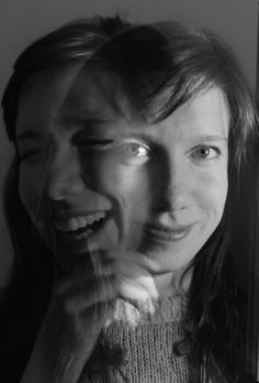 a black and white photo of a woman brushing her teeth