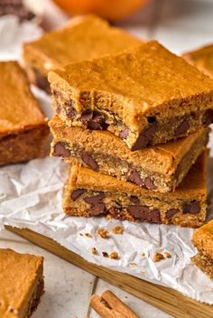 chocolate chip cookie bars stacked on top of each other with cinnamon sticks next to them