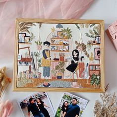 some pictures are laying on a table with pink tissue and other things to decorate it