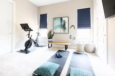 a home gym with exercise equipment and yoga mats