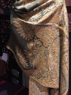 Deep olive green and beige Vintage styled wrap 28 X 70 inch Nice brocade paisley Very soft silk blend Styled from ancient Jamawar Indian motifs These are replicated from vintage shawl collections by my own company We may have larger quantities available for weddings, bridesmaids, or wholesale orders. Please inquire. All shipped free in the US Please check out our THOUSANDS of great reviews Green Pashmina Shawl In Traditional Drape, Green Jamawar Shawl With Traditional Drape, Elegant Green Pashmina Shawl, Gold Pashmina Shawl, Elegant Green Festive Pashmina Shawl, Elegant Green Shawl With Zari Work, Gold Bohemian Pashmina Shawl, Brown Pashmina Shawl With Paisley Print, Brown Paisley Pashmina Shawl