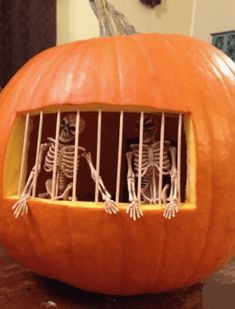 two skeletons in a jail cell carved into a pumpkin