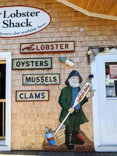 the lobster shack sign is painted on the side of the building with an image of a man holding a broom