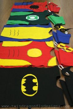 a group of children's t - shirts made to look like superheros are laid out on the floor