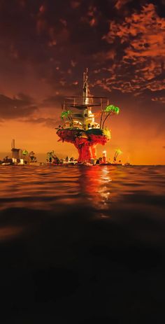 an oil rig floating on top of the ocean under a cloudy sky at night time