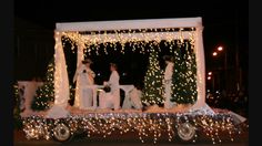 a decorated horse drawn carriage with people dressed in white