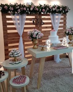 the dessert table is decorated with pink and white flowers