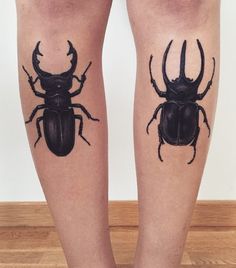 two black bugs on the legs of a person's legs, both with tattoos