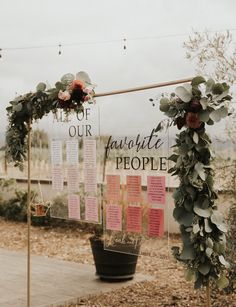 a couple of signs that are on the side of a road with flowers in them