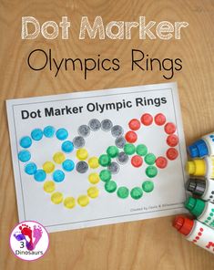 the dot marker olympics rings is next to some crayons