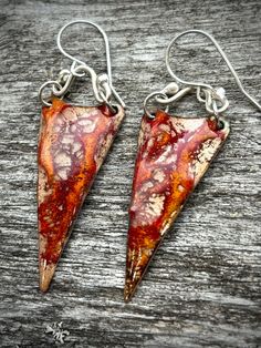 The rich colors of Autumn now in a pair of glass torch fired enamel earrings. These red and gold earrings are created by layering several layers of powdered glass onto copper and reveling the color underneath.  They are fired with a hand held torch and all the sterling silver findings are made by hand.  Due to the handmade nature of the process each piece will be unique.  The earrings are 2 1/2 inches long and 3/4 of an inch across . Artisan jewelry as unique and original as you are! One of a kind. Artisan jewelry as unique and original as you are!   VISIT ME ON FACEBOOK > https://www.facebook.com/ZenlemonArts/ Visit me on INSTAGRAM > https://www.instagram.com/zenlemonart/ Torch Fired Enamel, Torch Fired Enamel Jewelry, Enameled Jewelry, Autumn Jewelry, Colors Of Autumn, Dragon Claw, Fire Dragon, Fall Jewelry, Enamel Earrings