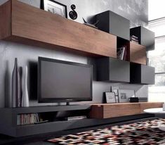 a living room with a large tv on the wall