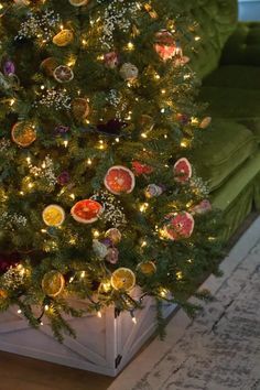 a decorated christmas tree in the corner of a living room