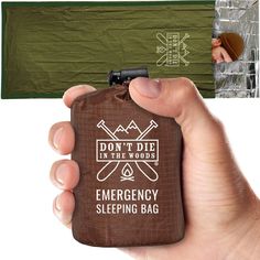 a person holding a brown emergency sleeping bag